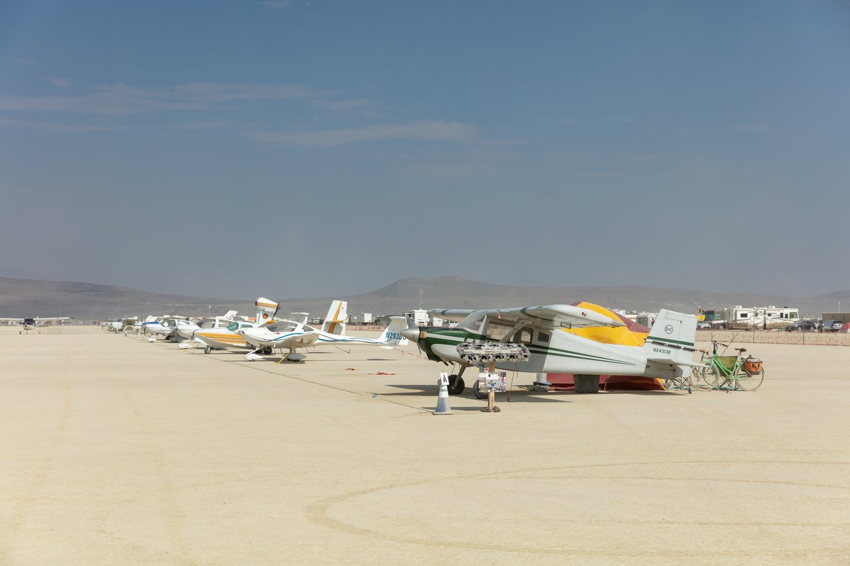 Note the tent behind the first plane. Many burners campout with their planes.