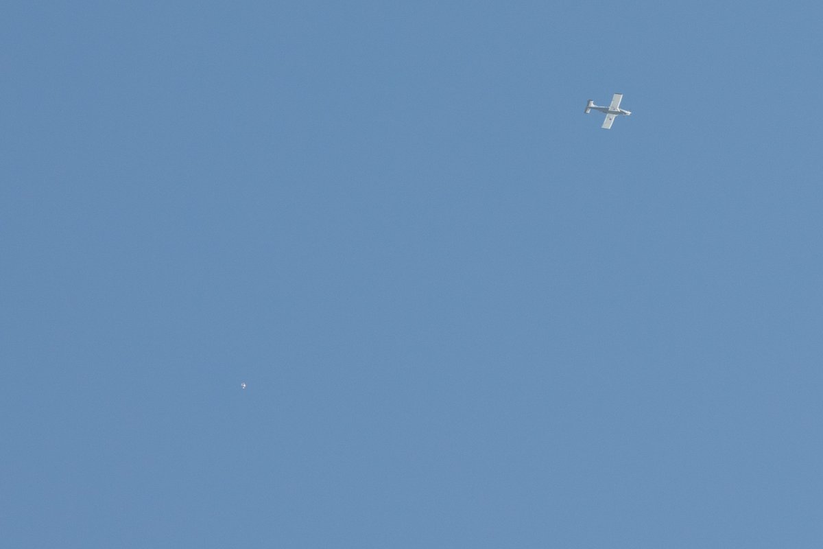 That little dot is a skydiver who just jumped out of that plane.