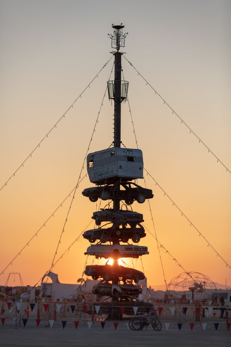 Night at the Climb In by: Dustin Weatherford from: Reno, NV year: 2018 Night at the Climb In will be a 70 foot tall stack of reclaimed junkyard cars, stacked straight up, one on top of the next. Every car will be climbable, visitable, interactive in its own way. The stack will end in a crows nest that sits at the top of the structure, just under a large spinning lit up sign. URL: https://www.facebook.com/nightattheclimbin/