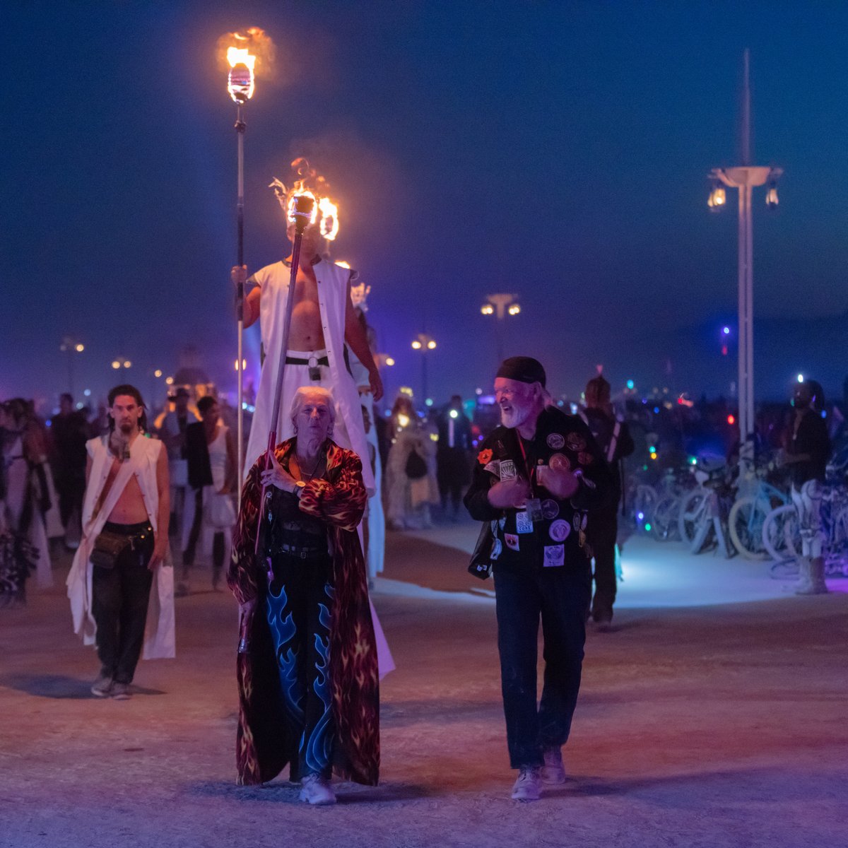 Carrying the flame that will light the fires for the fire conclave dancers.