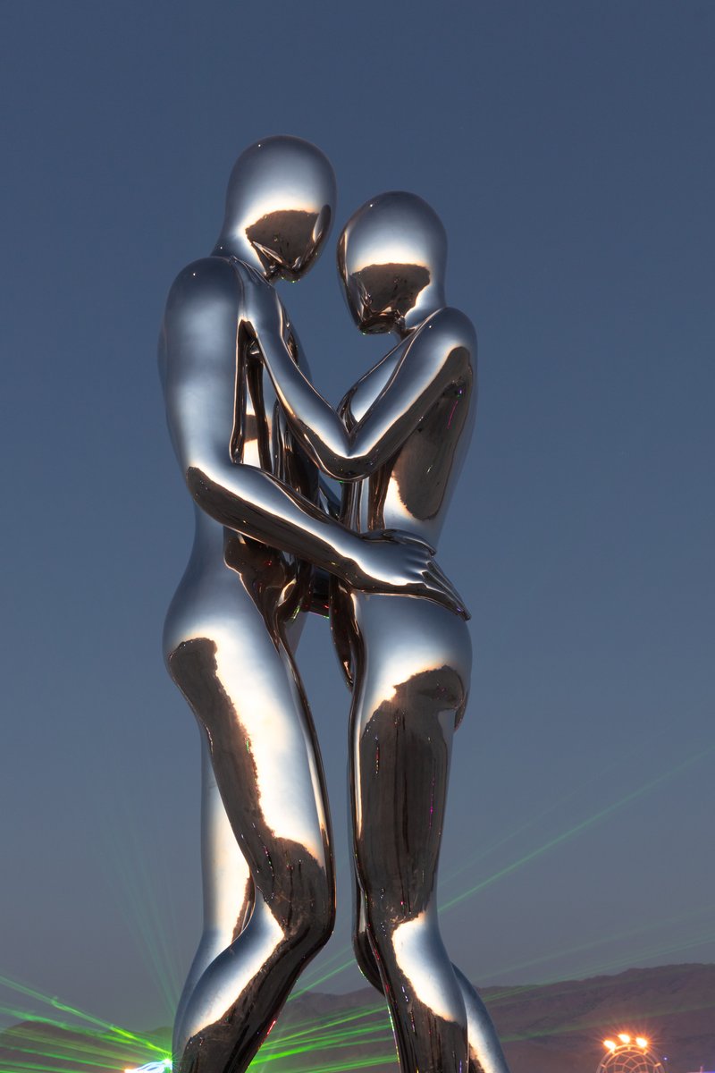 In Every Lifetime I Will Find You by: Michael Benisty, Love and Unity from: Brooklyn, NY year: 2018 A sculptural representation of Male and Female holding one another in a symbolic and universal position of caring in a display of Love and Unity. Measuring 25 feet tall and made out of mirror polished stainless steel.