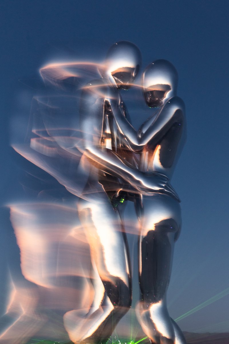 In Every Lifetime I Will Find You by: Michael Benisty, Love and Unity from: Brooklyn, NY year: 2018 A sculptural representation of Male and Female holding one another in a symbolic and universal position of caring in a display of Love and Unity. Measuring 25 feet tall and made out of mirror polished stainless steel.