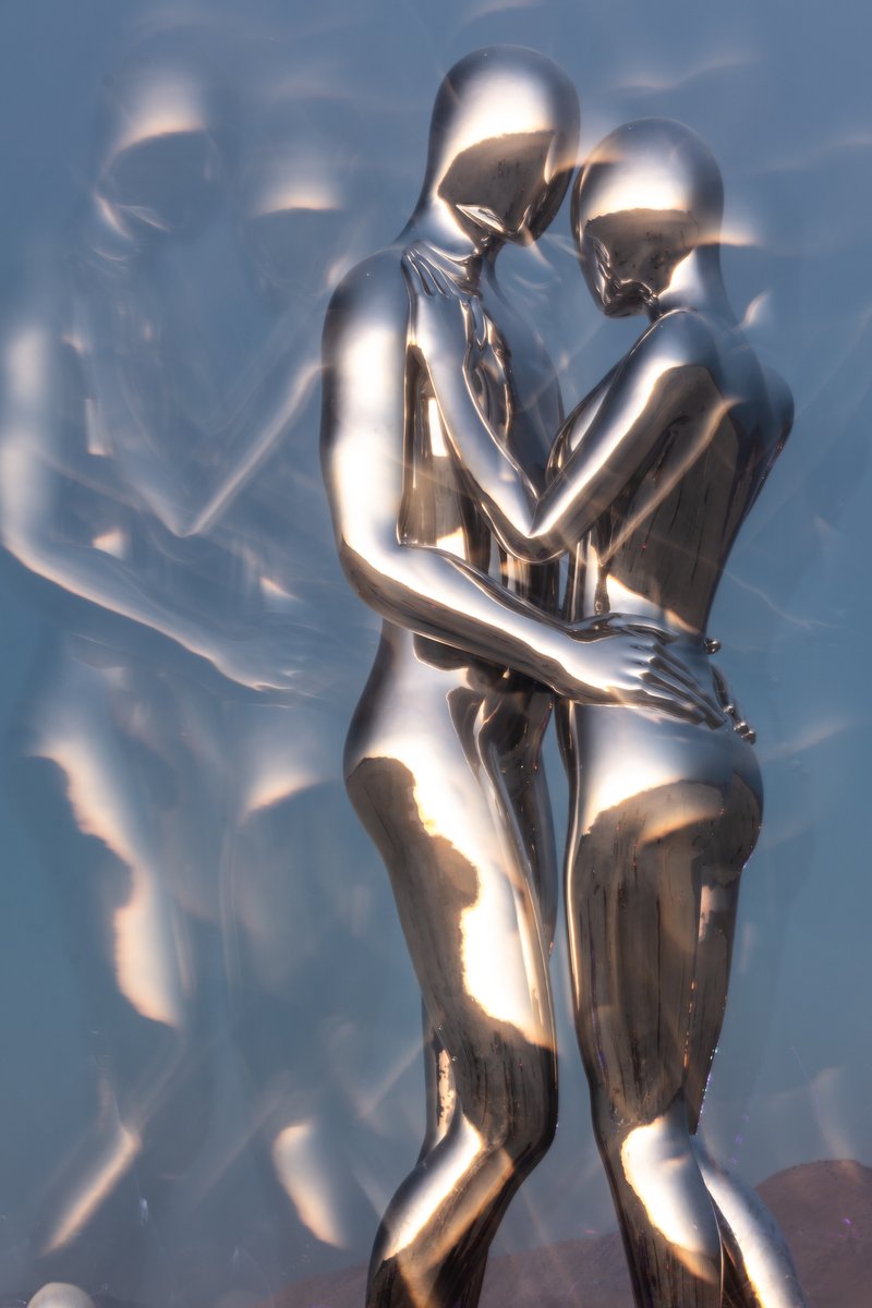 In Every Lifetime I Will Find You by: Michael Benisty, Love and Unity from: Brooklyn, NY year: 2018 A sculptural representation of Male and Female holding one another in a symbolic and universal position of caring in a display of Love and Unity. Measuring 25 feet tall and made out of mirror polished stainless steel.