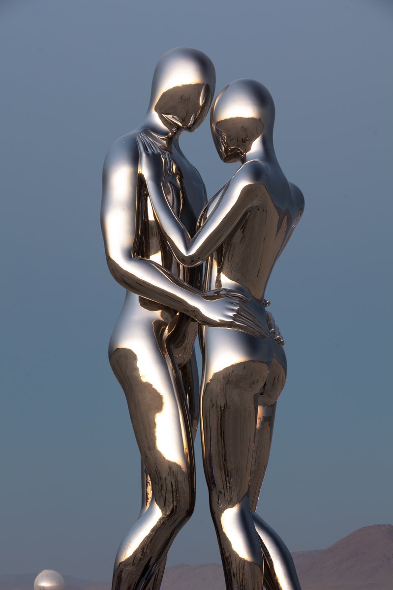 In Every Lifetime I Will Find You by: Michael Benisty, Love and Unity from: Brooklyn, NY year: 2018 A sculptural representation of Male and Female holding one another in a symbolic and universal position of caring in a display of Love and Unity. Measuring 25 feet tall and made out of mirror polished stainless steel.