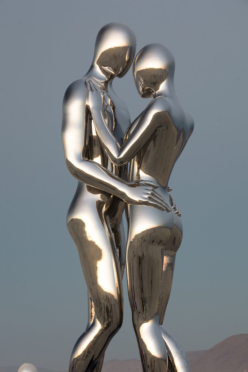 In Every Lifetime I Will Find You by: Michael Benisty, Love and Unity from: Brooklyn, NY year: 2018 A sculptural representation of Male and Female holding one another in a symbolic and universal position of caring in a display of Love and Unity. Measuring 25 feet tall and made out of mirror polished stainless steel.