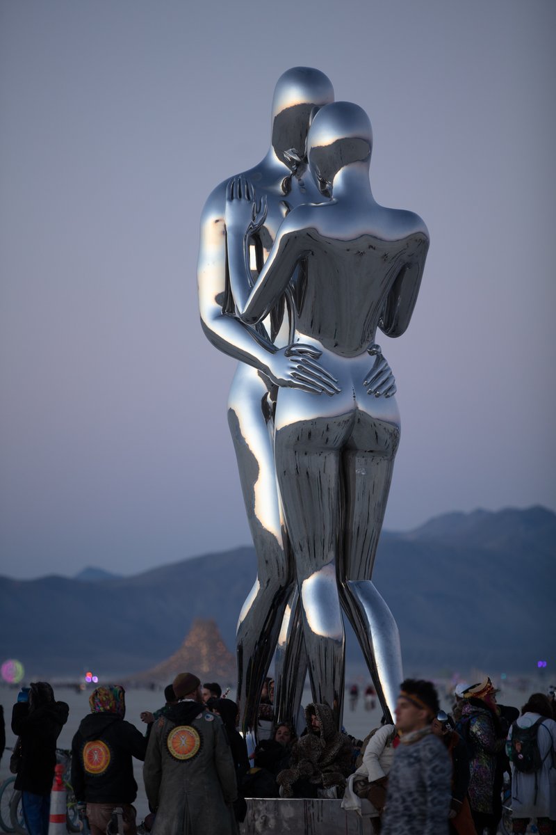 In Every Lifetime I Will Find You by: Michael Benisty, Love and Unity from: Brooklyn, NY year: 2018 A sculptural representation of Male and Female holding one another in a symbolic and universal position of caring in a display of Love and Unity. Measuring 25 feet tall and made out of mirror polished stainless steel.