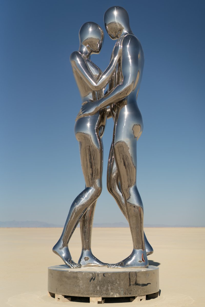 In Every Lifetime I Will Find You by: Michael Benisty, Love and Unity from: Brooklyn, NY year: 2018 A sculptural representation of Male and Female holding one another in a symbolic and universal position of caring in a display of Love and Unity. Measuring 25 feet tall and made out of mirror polished stainless steel.