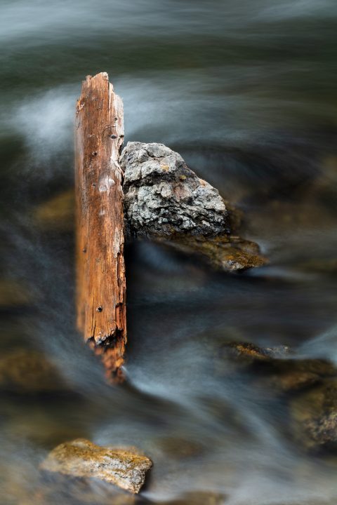 Flowing Water Versus Driftwood and Stone