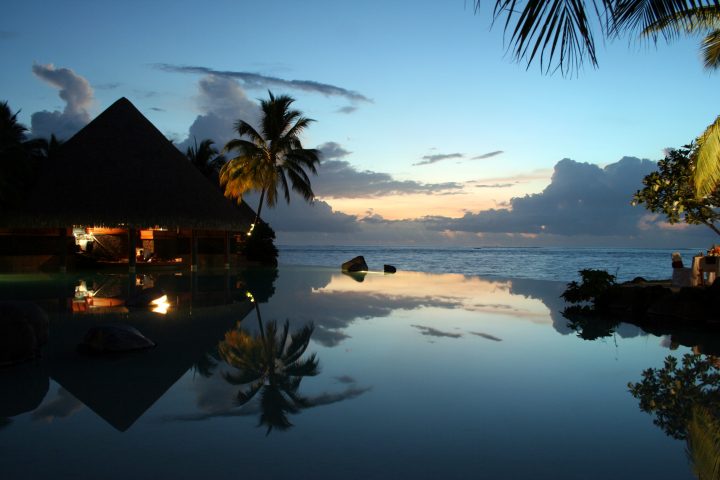 disappearing edge infinity pool at sunset with pool bar tahiti