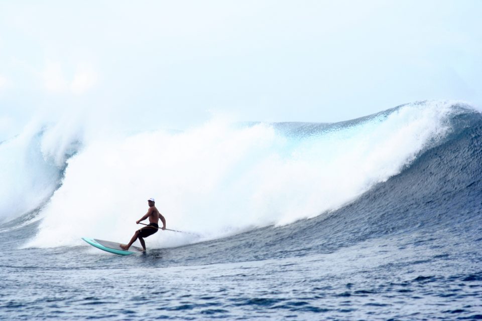 big wave paddle surfing