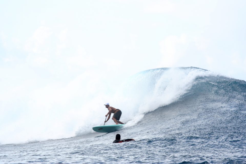 big wave paddle surfer