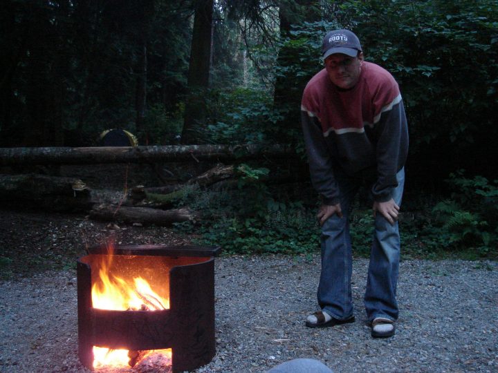 Duncan crouches by his fire