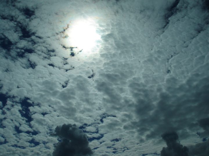 the sun burns a hole in the clouds