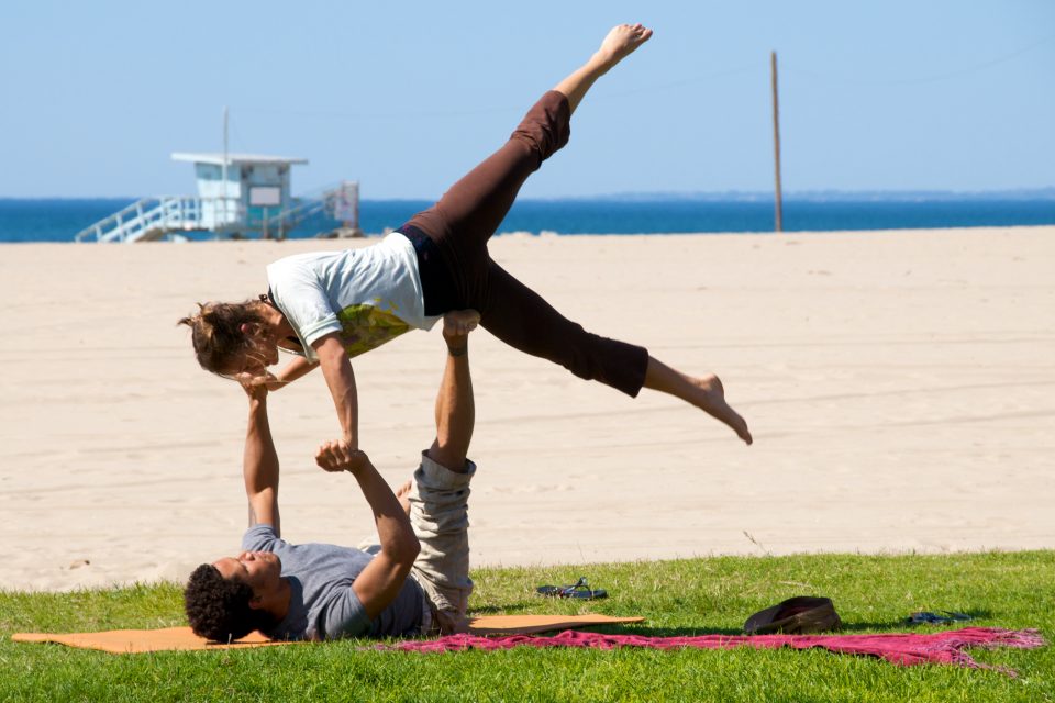 Couples Workout Doing Beach Yoga