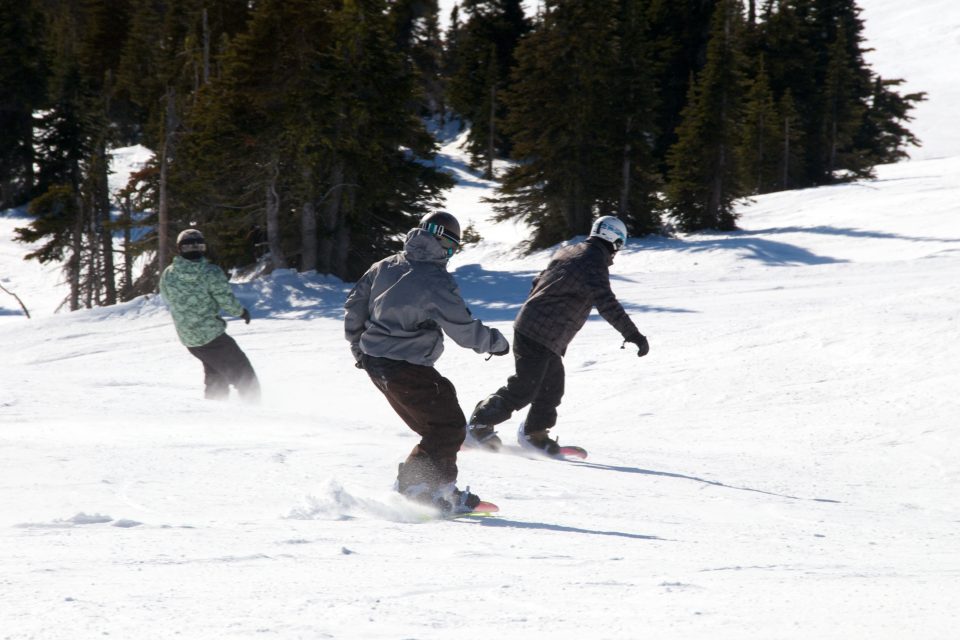 Snowboarders Riding