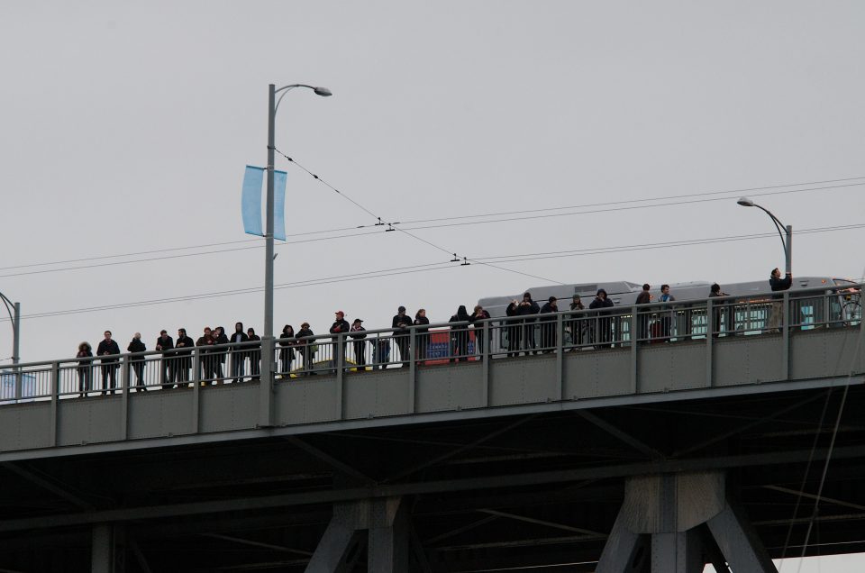 People look on from Granville Bridge