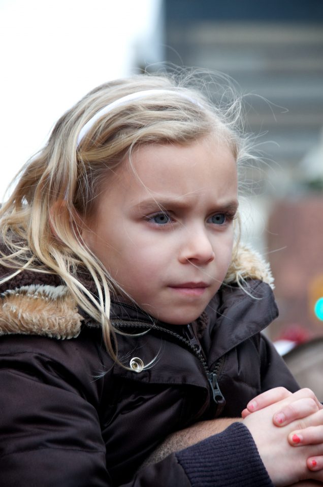 Young Girl Watches the Torch Relay Intently