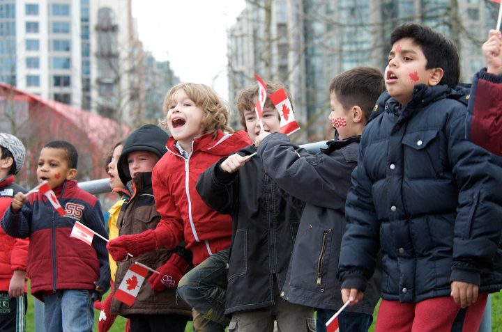 A Group of Kids Cheers on The Olympic Torch