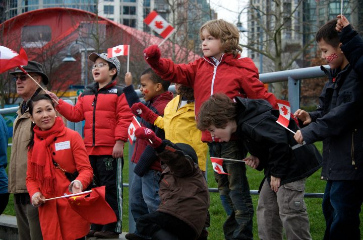 A Group of Kids Cheers on The Olympic Torch