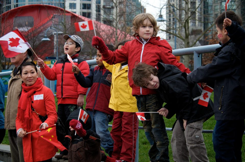 A Group of Kids Cheers on The Olympic Torch