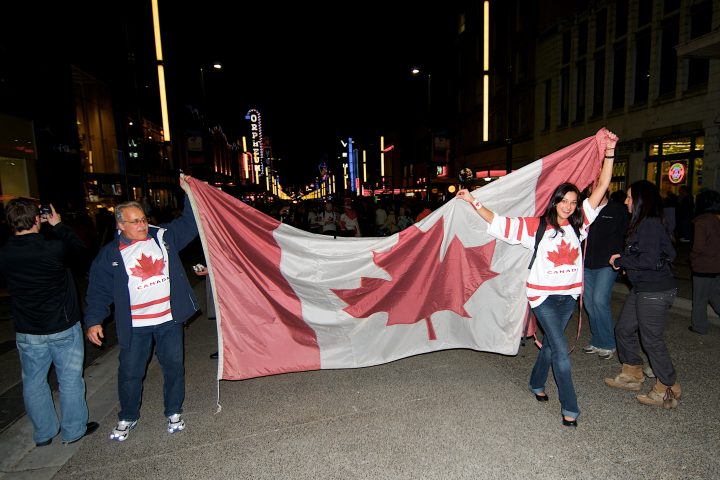 Father and Daughter Hold Canadian Flag