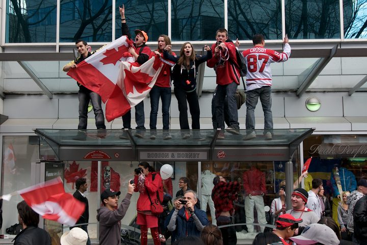 Celebrating Atop a Bus Shelter