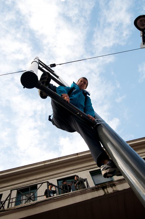 VANOC Volunteer Climbing Street Light