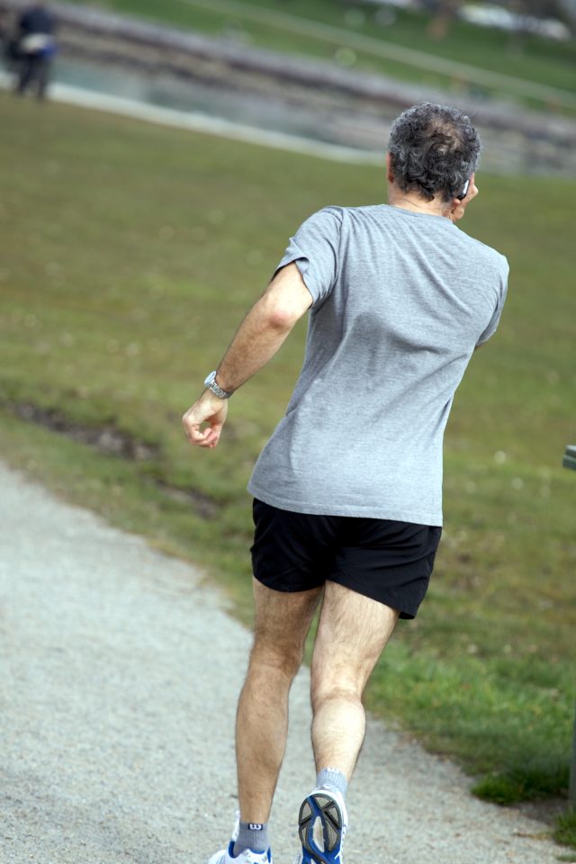Man Jogging and Talking on His Cell Phone At The Same Time