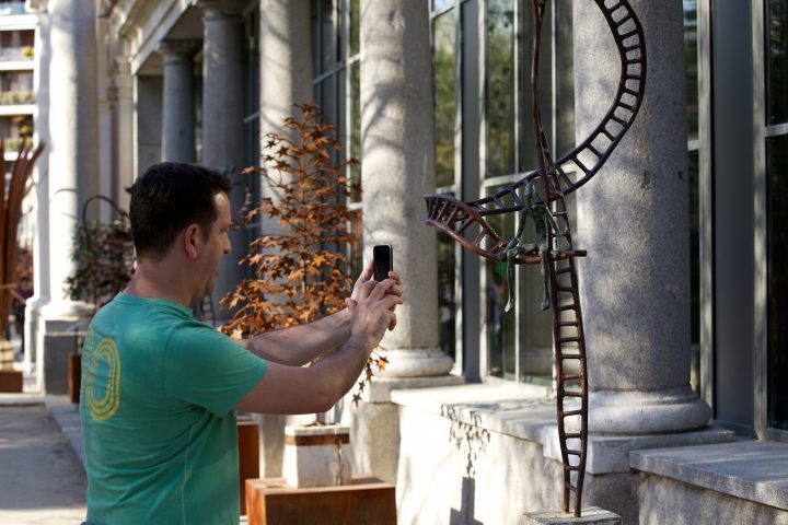 Man Photographs Sculpture at Royal Botanical Garden, Madrid