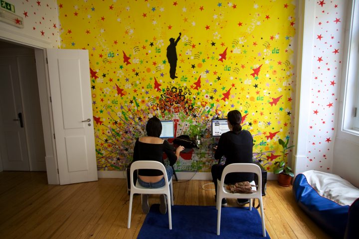 Two Girls Using Computers Lisbon Lounge Hostel