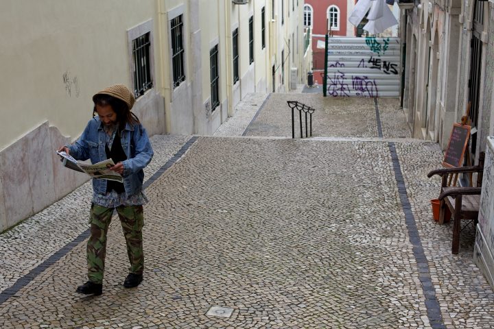 Man Walking and Reading Newspaper