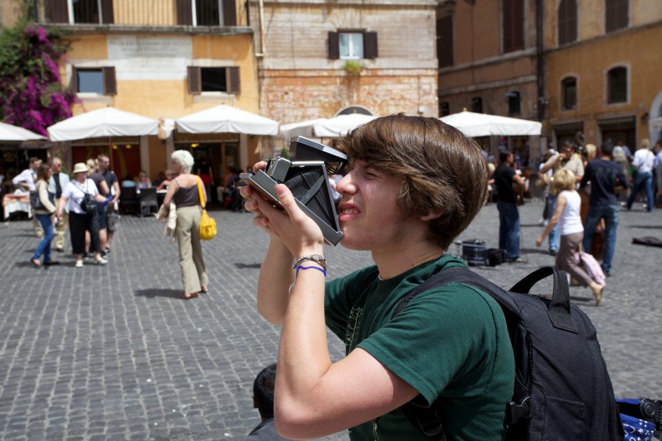 Young Man Using A Vintage Camera