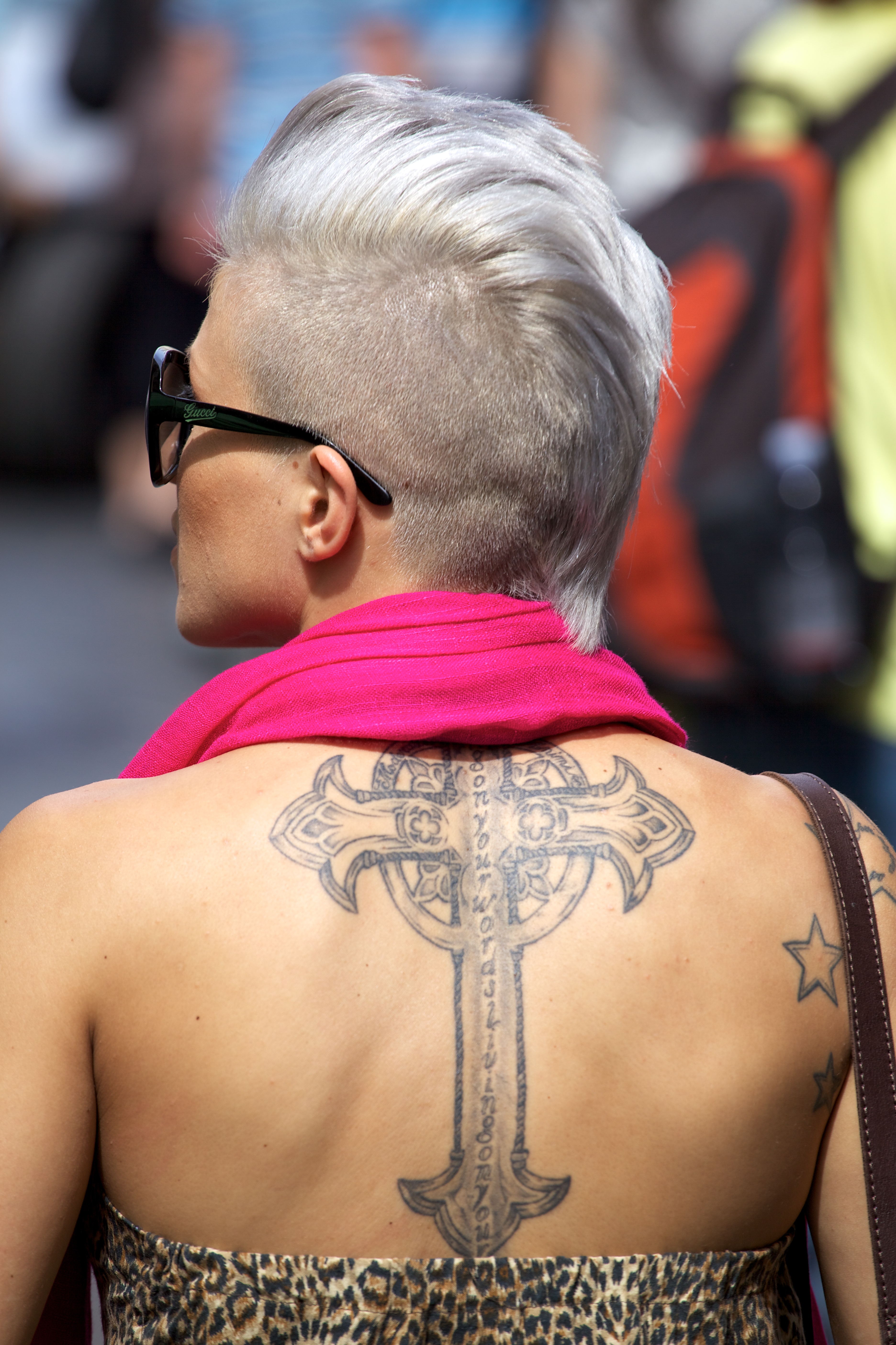 Woman With Large Cross Tattoo On Her Back in Rome 