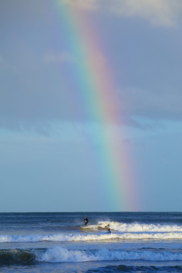Surfers And Rainbow