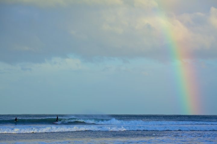 Surfers And Rainbow