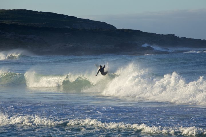 Surfer Carving Up A Wave