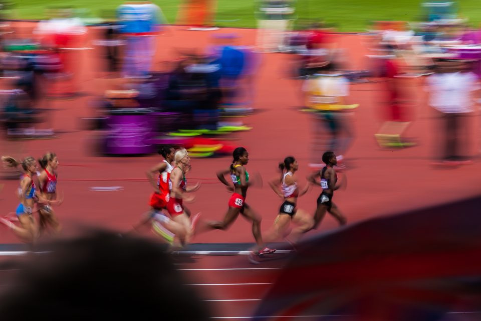 Athletes Run Fast as Fan Waves Flag London 2012 Olympics 0286