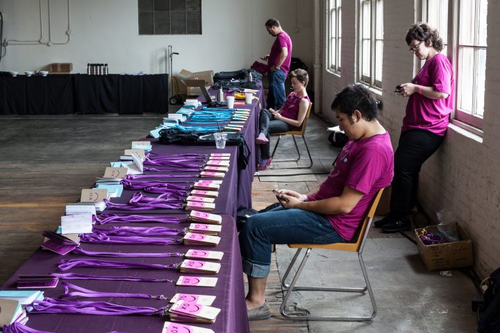 Volunteers On Their Phones XOXO 2013