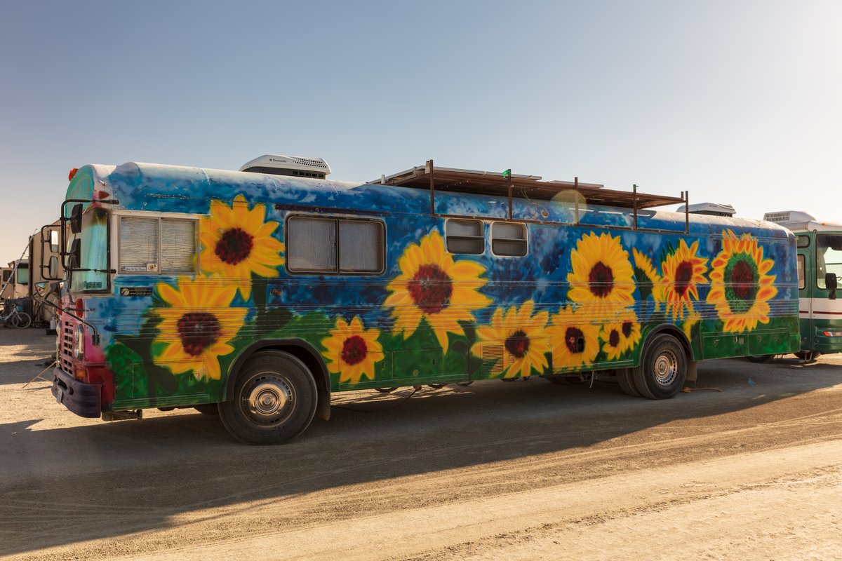 RV with sunflowers and solar panels.