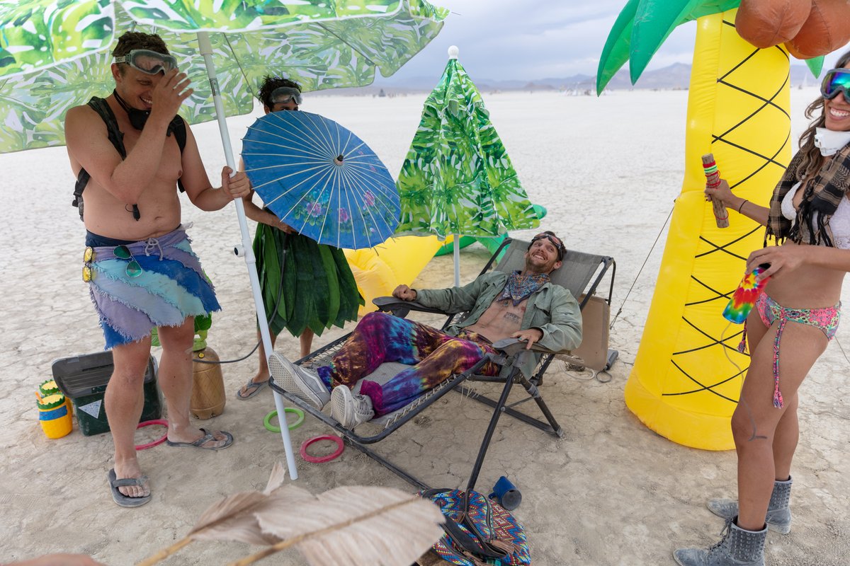 If memory serves this is called The Oasis. Random passerby burners get pampered and fanned. You get misted and they hand feed you fruit in the chair while you recline. Some people were trying to do one of those  colorful smokebomb photoshoots upwind from us. The smoke was so thick we could barely breath. I went over and politely asked them if they could take their photoshoot elsewhere. I also asked them to think about whether or not smokebombs are MOOP...