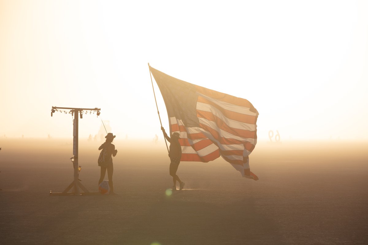Burner holding large American flag.