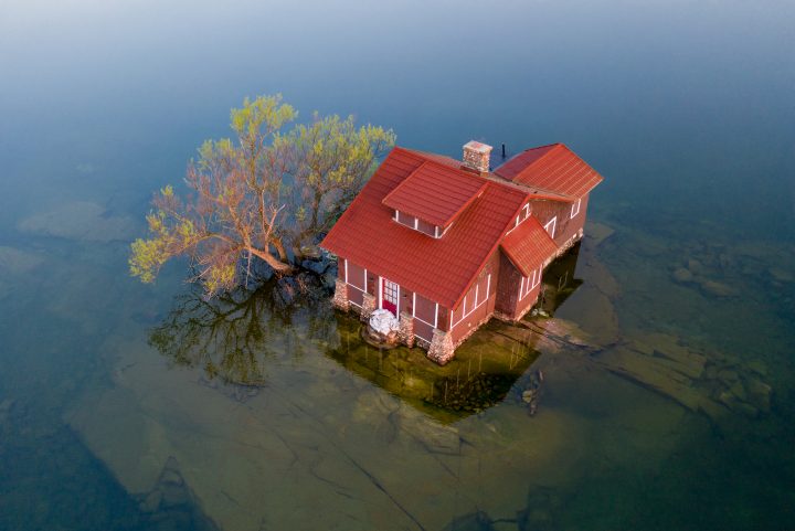 Tiny Island With Red Cottage