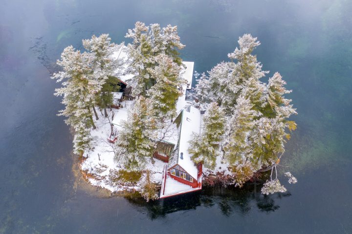 Small Snow Covered Island and Cottage