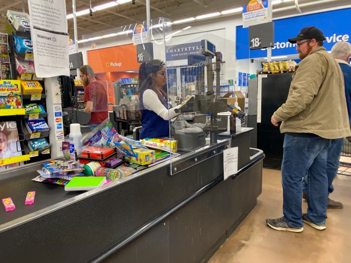 Walmart Employee Behind Protective Barrier