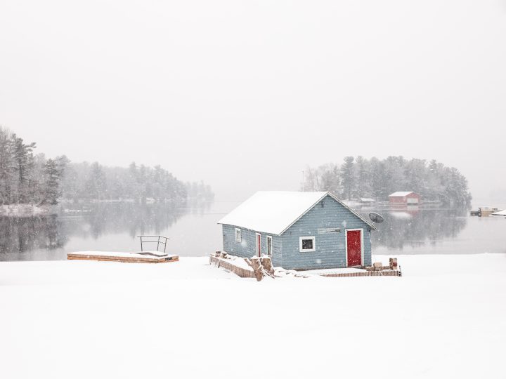 Boathouse with Red Door in the Snow