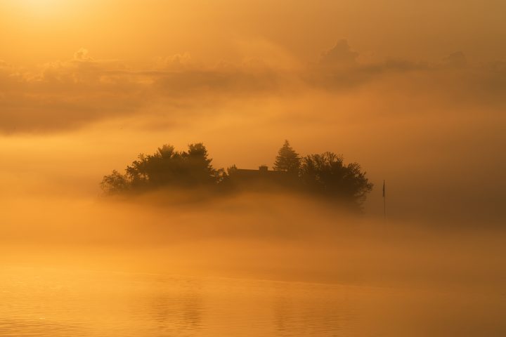 Small Island Shrouded in Fog at Sunrise