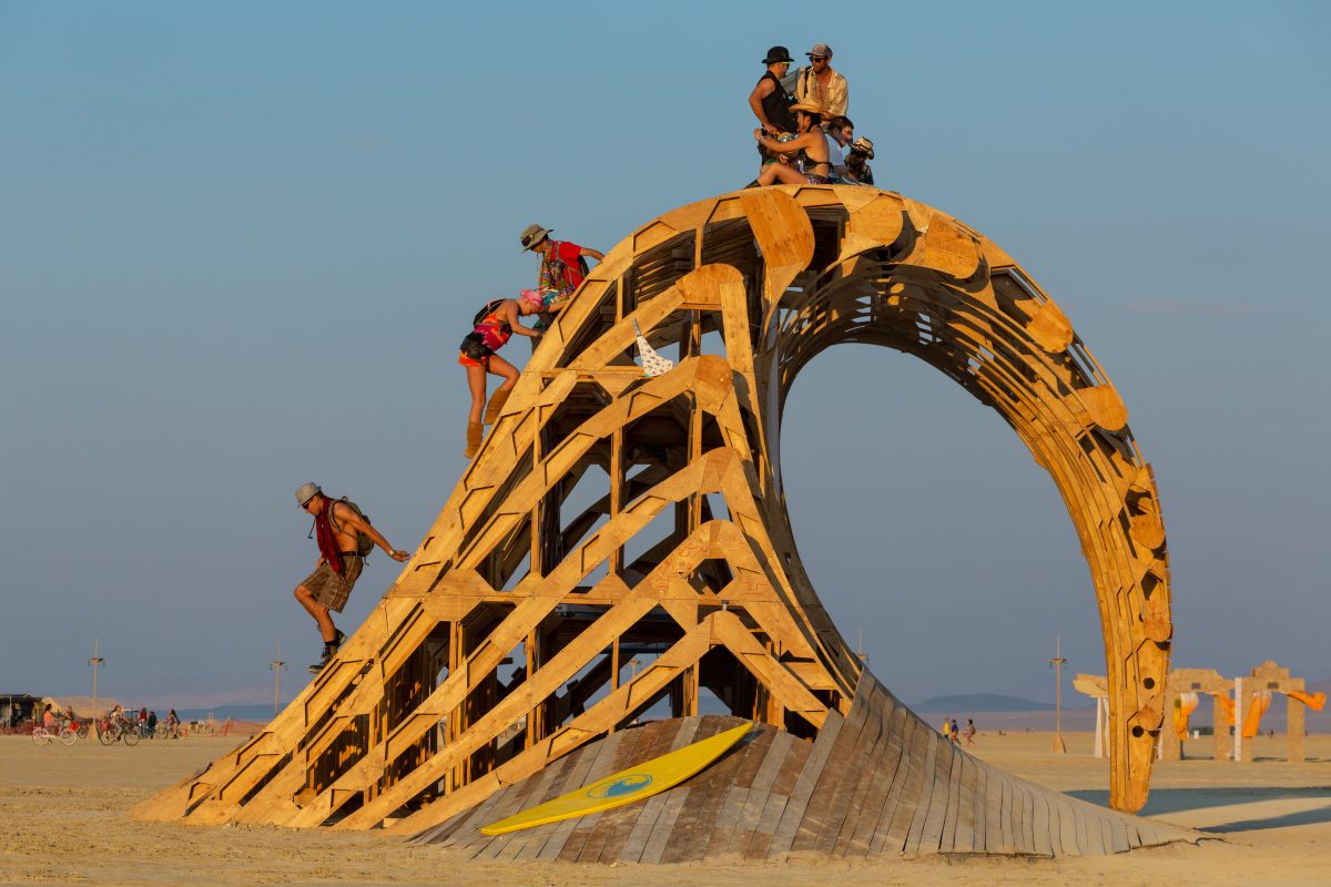 Cruz the Wave by: Santa Cruz Burners year: 2014  Cruz the Wave is a large wooden curling surf wave that will rise 18′ out of the playa. Playa colored during the day, it will be lit with thousands of programmable LEDs at night. Contact: info@cruzthewave.org
