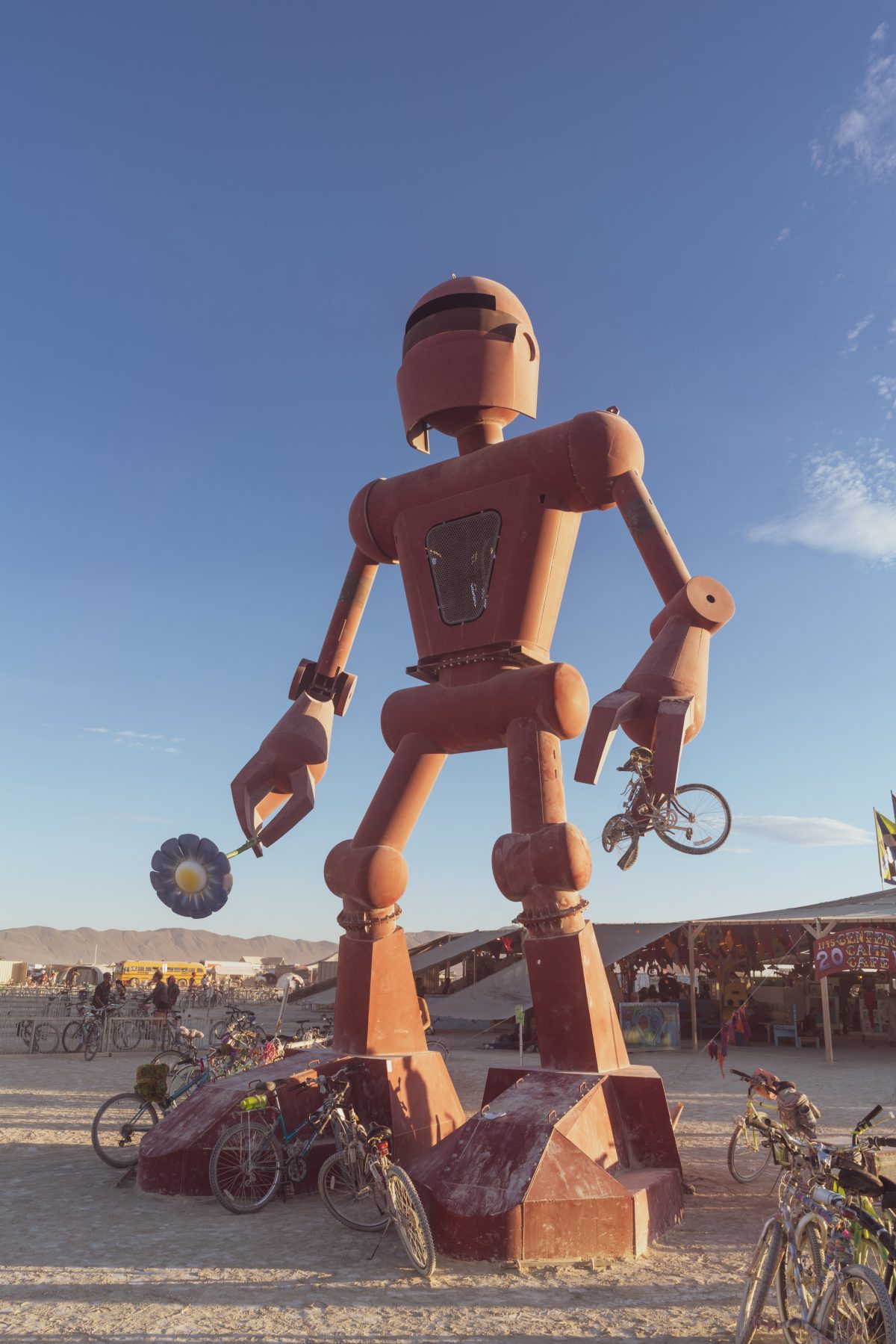 Becoming Human from: El Prado, NM year: 2015  Becoming Human is a 30-foot tall sculpture of a robot, which occasionally smells the flower in its right hand. The sculpture hopes to inspire viewers to ask questions about technology and nature, and the value of slowing down. Contact: crobox@gmail.com