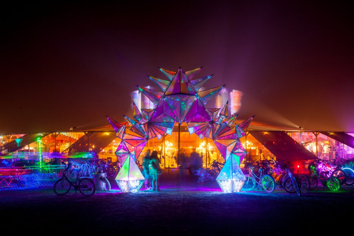 Pulse Portal from: Chicago, IL year: 2016  A portal acts as a gateway to a distant and magical world. Pulse Portal is a freestanding laser cut parabolic archway made from steel and tessellated dichroic acrylic pyramids. Juxtaposing futuristic materials that reflect the viewer and the rugged lands...