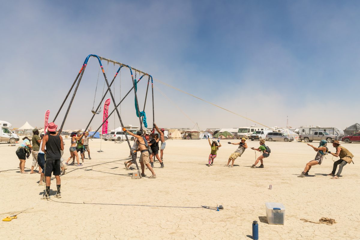 Burners work together to put up a swing.
